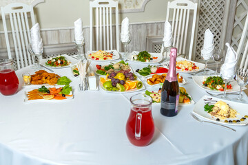Snack drinks and fruits on the banquet table with white tablecloth.