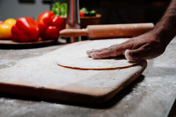 men's hands sprinkle flatbread with flour. simple baking recipes