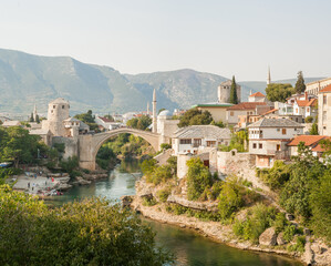 Fototapeta na wymiar Old town of Mostar, Bosnia and Herzegovina. Old bridge above beautiful emerald river Neretva