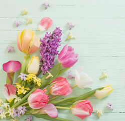 spring flowers on green wooden background