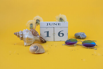  Calendar for June 16: cubes with the number 16, the name of the month of June in English, shells,...