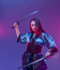 Eastern female warrior with katanas in fight stance