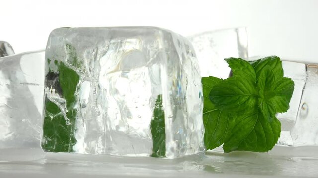 Ice cubes and mint leaves. Rotating 4k video.