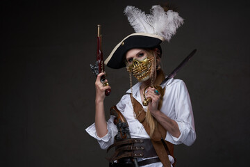 Fototapeta premium Female buccaneer with mask against dark background