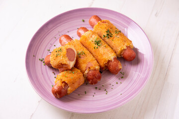 Flamenquines. Traditional Spanish tapa. Breaded sausage wrapped with ham and cheese.
