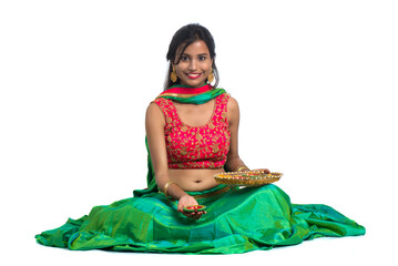 Portrait of a Indian Traditional Girl holding Diya, Girl Celebrating Diwali or Deepavali with...