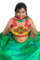 Portrait of a Indian Traditional Girl holding Diya, Girl Celebrating Diwali or Deepavali with...
