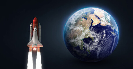Space shuttle in outer space. Rocket on orbit of the planet. Space ship in galaxy. Vertical...