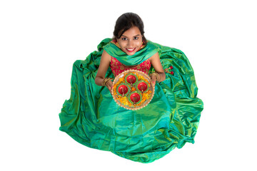 Portrait of a Indian Traditional Girl holding Diya, Girl Celebrating Diwali or Deepavali with...