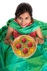 Portrait of a Indian Traditional Girl holding Diya, Girl Celebrating Diwali or Deepavali with...