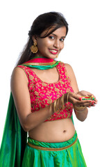 Portrait of a Indian Traditional Girl holding Diya, Girl Celebrating Diwali or Deepavali with...