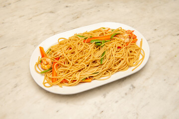 Sauteed spaghetti with vegetables and prawns in oriental style