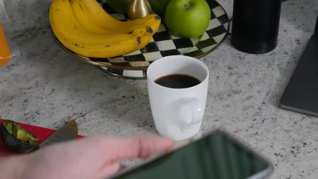 Man holds up iPhone green screen