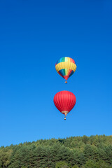 Multicoloured hot air balloon in the sky on a beautiful summer morning on the Balloon festival.