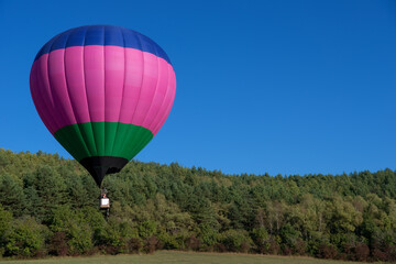 Multicoloured hot air balloon in the sky on a beautiful summer morning on the Balloon festival.