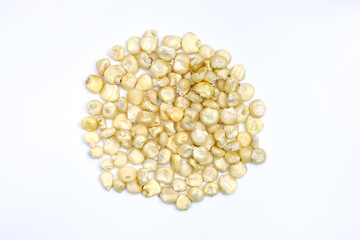 Dry grains of corn on a white background. Yellow grains of corn top view. Seeds for planting in the ground.