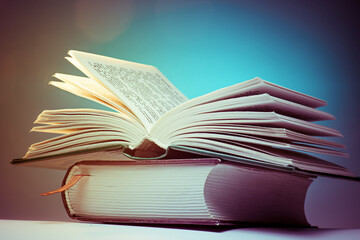 Two books on a blue background. One book is open.