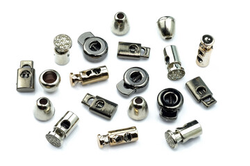 Locks on metal laces of different shapes on a white background. Sewing accessories for creating clothes. Closure, clip for textile cord.