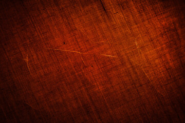 Texture of dark red shabby with scratches cotton fabric, close-up. Red textile background.