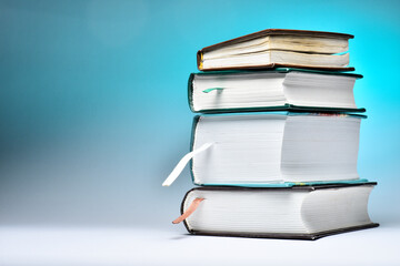 Thick books on a blue background,