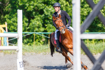 Young man on his course show jumping competition