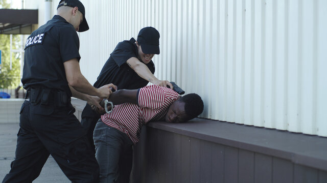 Police officers arresting black man