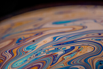 Macro picture of half soap bubble psychedelic color on black background