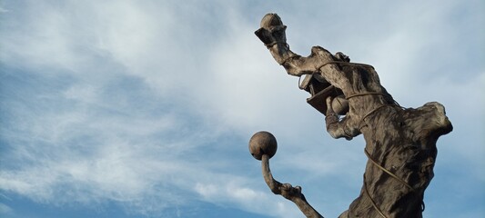 bird house on old wooden tree on cloudy blue sky