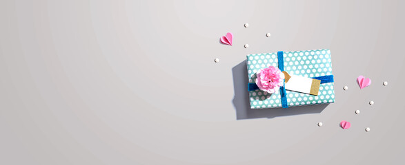 Gift box with a pink carnation flower