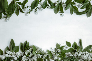Floral arrangement with spring leaves and flowers copy space.