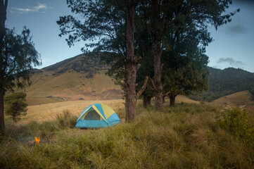 Camping with hills in the background.