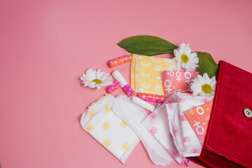 Menstrual tampons and pads in cosmetic bag. Menstruation cycle. Hygiene and protection
