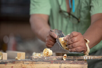 Mexican carpenter working in his workshop, close-up