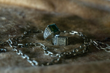 silver rings, one signet style and one with gold and onyx