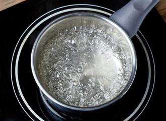 kettle of boiling water on electric induction hob