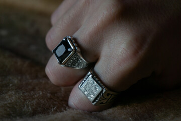 silver rings, one signet style and one with gold and onyx