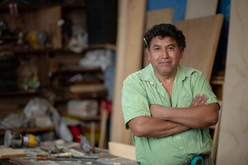 Portrait of a Mexican woodworker, carpenter on his workshop