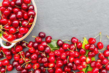 Fresh crop of cherry berries on a stone gray countertop.