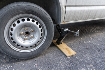 A jack stands up a car.