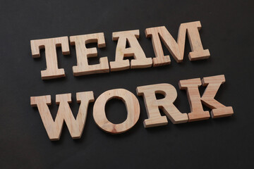 Fototapeta na wymiar Teamwork, text words typography written with wooden letter on black background, life and business motivational inspirational
