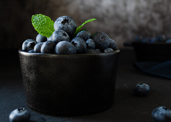 Blueberries in bowl dark background