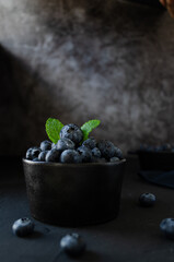 Blueberries in bowl dark background