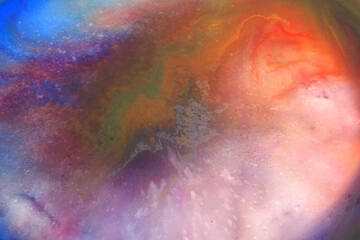 Blurred colorful abstract background : The movement of colors on liquid surface in white porcelain plate (Photography with soft focus and blurred appearance)
D