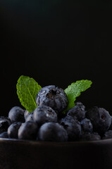 Blueberries in bowl dark background