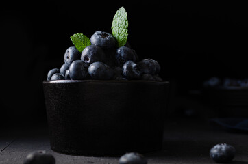 Blueberries in bowl dark background
