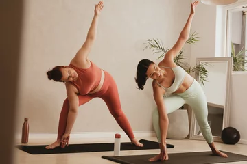 Foto op Plexiglas Women performing a yoga routine at gym © Jacob Lund