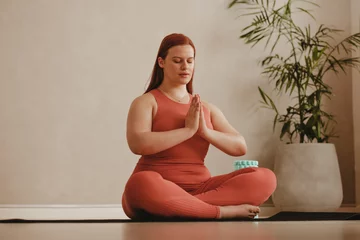  Fitness woman meditating in lotus pose © Jacob Lund
