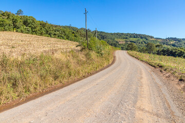 Fototapeta na wymiar Dirty road with farms around