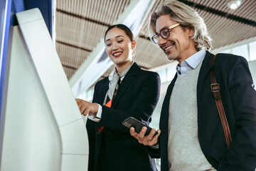 Flight attendant assisting passenger at airport