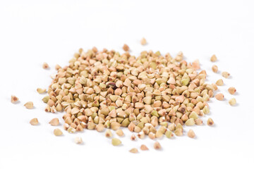 Pile of raw buckwheat isolated on white background.